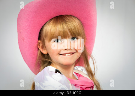 Piuttosto 3 anno vecchia ragazza sorridente e indossando un colore rosa in stile cowboy hat Foto Stock