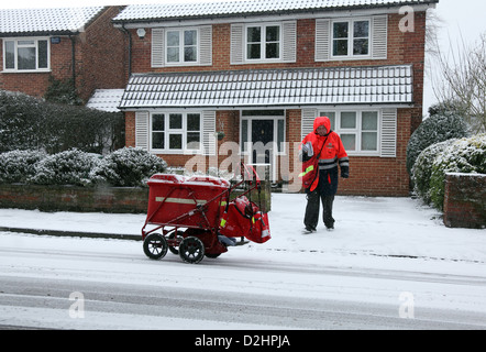 Postino recapita la mail a Londra nel gennaio nevicata. Foto Stock