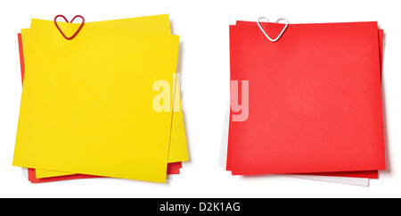 Giallo e rosso sticky notes con fermaglio a forma di cuore su sfondo bianco Foto Stock