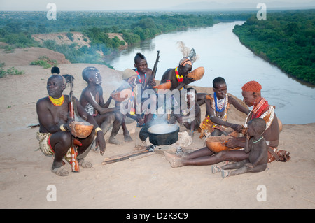 New Scenic 5 posti del gruppo di decorate Kara uomini, donne e bambini intorno al recipiente di cottura-Omo river sotto Foto Stock