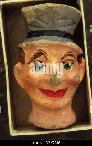 Martoriato e scheggiati cartapesta maschio fantoccio testa con top hat giacente nel vassoio di cartone Foto Stock