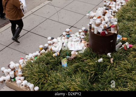 Scartato tazze da caffè trabocca dal cestino su strada pubblica Foto Stock