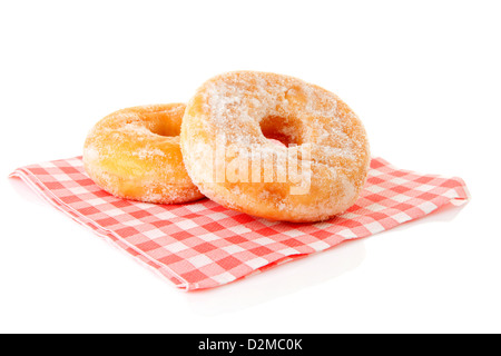 Due deliziose ciambelle zuccherata sul tovagliolo su sfondo bianco Foto Stock