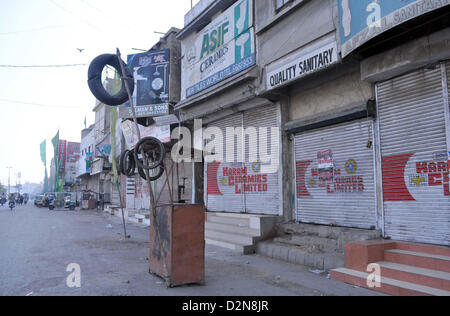 Negozi visto chiuso dopo che il target di uccisione di due attivisti del Muttehda Qaumi movimento in area Gulbahar a Karachi il Martedì, 29 gennaio 2013. Foto Stock