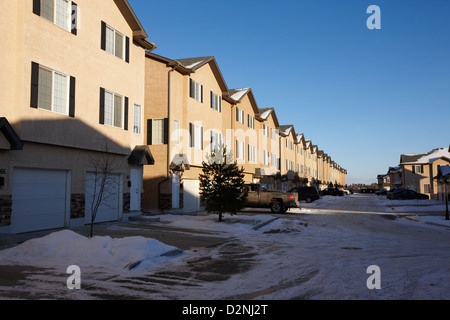 Fila di condominio case del motorino di avviamento durante l'inverno Saskatoon Saskatchewan Canada Foto Stock