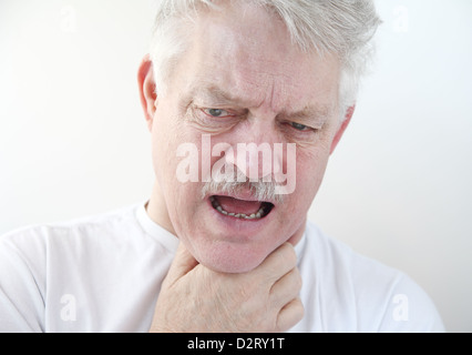 Senior con una mano sulla sua dolorosa di gola Foto Stock