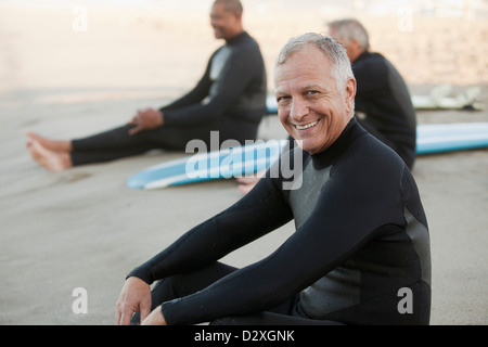 I vecchi surfers seduta su schede sulla spiaggia Foto Stock
