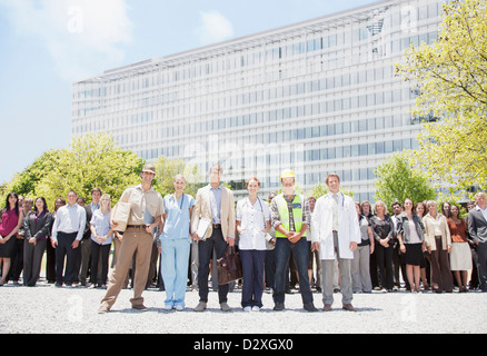 Ritratto di professionisti e lavoratori con la folla di gente di affari in background Foto Stock