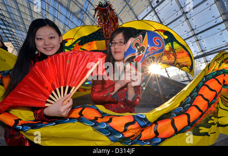 Cinese Yixing Gui (L-R) e Yu Jieqiong tenere un coloratissimo dragone cinese in occasione della prossima Home-Garden-Tempo Libero fiera consumatori a Leipzig, Germania, 06 febbraio 2013. Questo anno di Home-Garden-Tempo Libero fiera consumatori si concentra su Asia e ha luogo dal 09 fino al 17 febbraio 2013. Foto: HENDRIK SCHMIDT Foto Stock