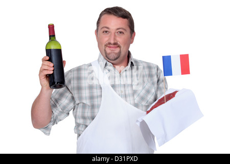 Il francese con una bottiglia di rosso e una bistecca di greggio Foto Stock