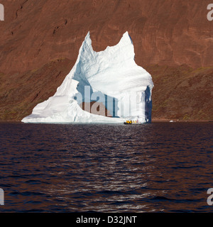 Turisti in un zodiac esplorando gli iceberg, Scoresbysund, Groenlandia Foto Stock