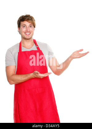 Sorridenti maschio caucasico business negozio proprietario indossa grembiule rosso mostra o la presentazione isolata su sfondo bianco Foto Stock