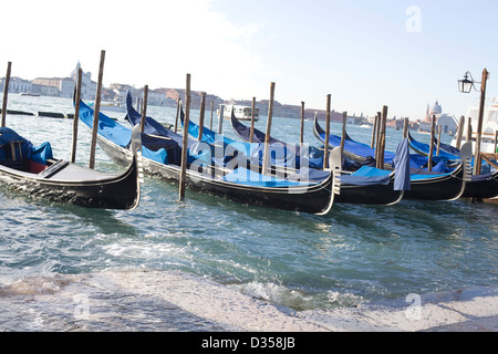 Gondola tradizionali a fondo piatto veneziano barca a remi lungo il Canal Grande a Venezia Italia Foto Stock