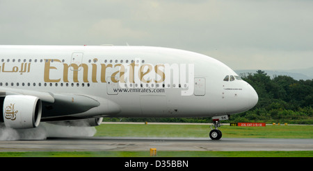 Emirates Airlines Airbus A380 861 E6 EDK atterra su una pista bagnata all'Aeroporto di Manchester Foto Stock