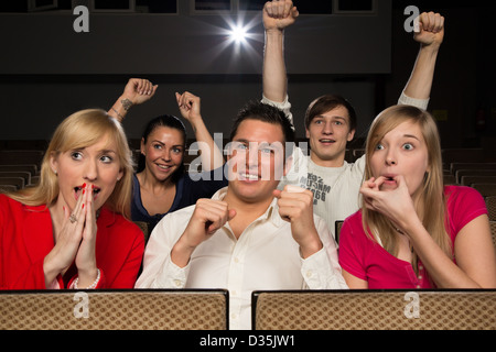 Udienza in movie theater tifo e applaudire Foto Stock