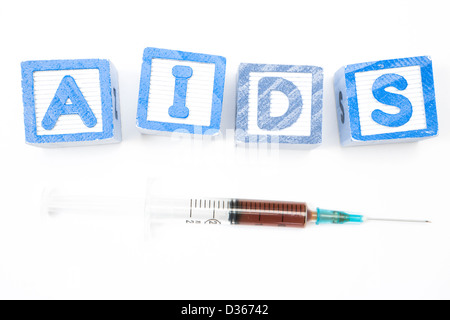 I blocchi di legno compitazione aids con siringa Foto Stock