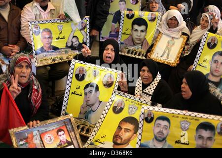 Febbraio 11, 2013 - Gaza City, nella Striscia di Gaza, Territori Palestinesi - le donne palestinesi tenere le foto dei prigionieri detenuti nelle prigioni israeliane durante una manifestazione di protesta per chiedere la liberazione di prigionieri palestinesi dalle carceri israeliane di fronte all'ufficio della Croce Rossa di Gaza City, 11 febbraio, 2013 (credito Immagine: © Ashraf Amra/immagini APA/ZUMAPRESS.com) Foto Stock