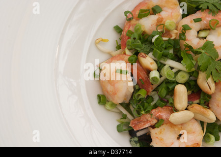 Insalata di gamberi con menta, basilico e croccante di arachidi è servito in una ciotola bianco Foto Stock