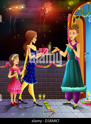 Le donne dando dono al suo prossimo in occasione del Diwali Foto Stock