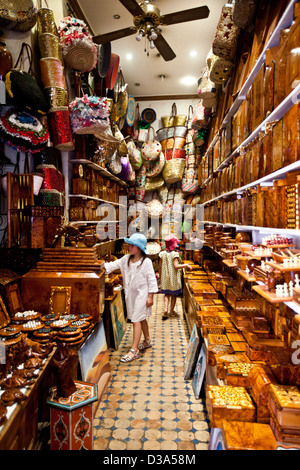 I bambini guardando al negozio di souvenir nel souk di Marrakech, Marocco Foto Stock