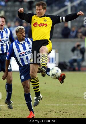 (Dpa) - Berlino centrocampista brasiliano Marcelinho (C) combatte per la palla con Dortmund è difensore e capitano della squadra Stefan Reuter (anteriore) mentre Marcelinho il belga del team mate Bart GOOR (L) si affaccia su durante la Bundesliga soccer game Borussia Dortmund contro Hertha BSC Berlin a Berlino, 25 gennaio 200 Foto Stock