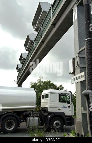 (Dpa) - un carrello di guida è sotto un ponte a pedaggio in autostrada a 555 vicino a Colonia, Germania, 21 maggio 2003. Il ponte ha un cartello che diceva "Testbetrieb' significa eseguire la prova di funzionamento. Inizia il 1 settembre 2003, i conducenti di veicoli pesanti dovranno pagare un pedaggio autostradale in Germania. Negli ultimi dibattiti il pedaggio ha Foto Stock