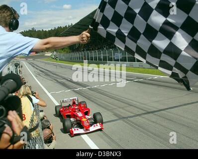 (Dpa) - tedesco di formula one champion Michael Schumacher della Ferrari attraversa la linea del traguardo, vincendo il Gran premio d'Austria sulla A1-Ring racetrack in Zeltweg, nei pressi di Spielberg, Austria, 18 maggio 2003. È la sua terza vittoria di questa stagione. Foto Stock