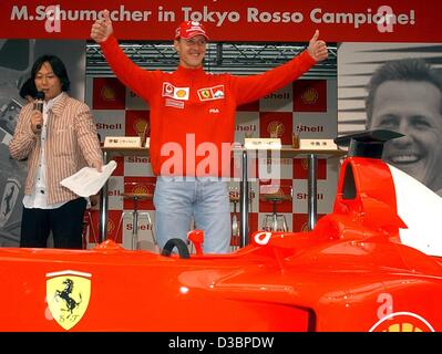 (Dpa) - Tedesco pilota di Formula Uno Michael Schumacher della Ferrari onde per i tifosi, durante un evento di sponsor a Tokyo il 8 ottobre 2003. Il sedicesimo e ultimo round della Formula Uno Campionati del Mondo si terrà a Suzuka, circa 300 km a sud-ovest di Tokyo, domenica 12 ottobre. Foto Stock