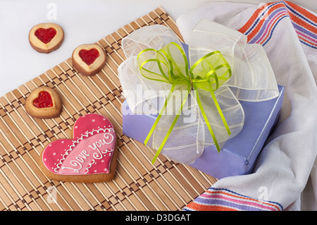 Decorate con iscrizione a forma di cuore biscotti per il giorno di San Valentino e confezione regalo con un inchino Foto Stock