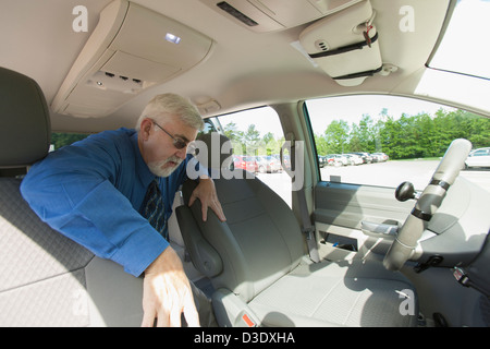 Uomo con la distrofia muscolare e il diabete di salire in un furgone accessibile Foto Stock
