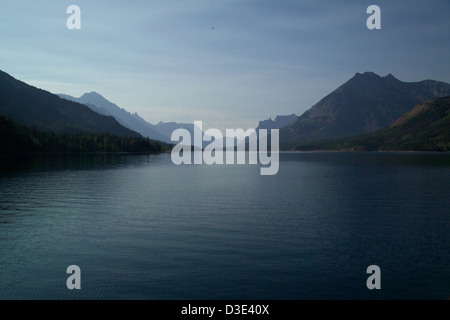 Lago Waterton, situato nel Waterton-Glacier International Peace Park, a cavallo del confine tra Canada e Stati Uniti. È una caratteristica fondamentale del Glacier National Park, noto per i suoi splendidi paesaggi glaciali, le viste panoramiche e la presenza di ghiacciai. I visitatori possono esplorare la zona in barca e godersi le pittoresche montagne e il tranquillo lago glaciale. Foto Stock