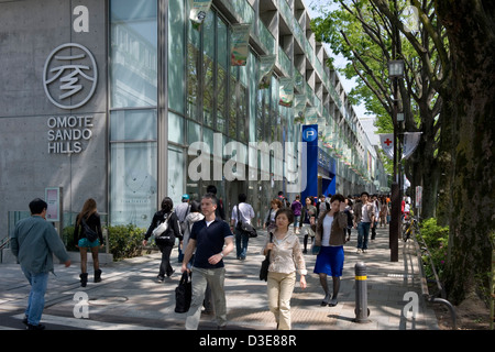 Gli amanti dello shopping passeggiando passato Omotesando Hills shopping mall lungo Omotesando-dori Street nell'esclusivo Shibuya di Tokyo, Giappone. Foto Stock