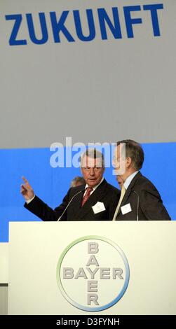 (Dpa) - Werner Wenning (L), il CEO del gruppo chimico tedesco Bayer, gesti come egli parla con Heinrich von Pierer, un membro del Consiglio di Sorveglianza, sotto la parola "Zukunft" (futuro) davanti all'assemblea generale a Colonia, Germania, 25 aprile 2003. Bayer AG detto 25 Aprile che si aspetta una crescita a doppia cifra del suo utile operativo nel 2003, provvisoria con primo trimestre Foto Stock