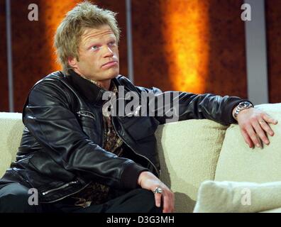 (Dpa) - Professional soccer portiere Oliver KAHN (R) di FC Bayern Monaco di Baviera si rilassa su un lettino con i suoi occhi guardando verso l'alto durante il tedesco show televisivo "Wetten Dass, ...?" ("scommettere che ...?") di Berlino, Germania, 22 febbraio 2003. Foto Stock