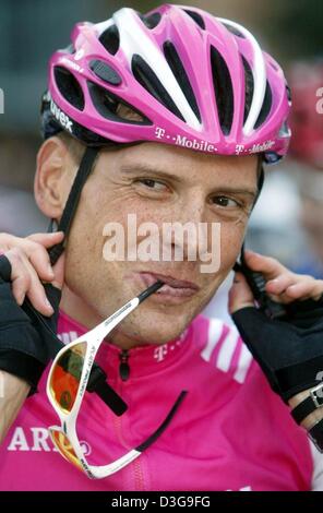 (Dpa file) - ciclista tedesco Jan Ullrich fissa il suo casco davanti a una gara di Heppenheim, Germania, 27 agosto 2004. L'ex vincitore del Tour de France ha detto Mercoledì, 22 settembre 2004, che gareggerà in occasione dell'imminente del campionato del mondo di ciclismo in Italia. Ullrich ha detto sul sito web della sua T-Mobile team che gareggerà nel tempo in prova e la gara su strada in un obiettivo di fine t Foto Stock