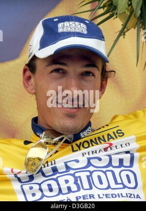 (Dpa) - Swiss Fabian Cancellara del team Fassa Bortolo mette sul leader della corsa la maglia gialla dopo la prima tappa del Tour de France a Charleroi (Belgio), 4 luglio 2004. 23-anno-vecchio Cancellara ha fatto vincere anche il prologo del Tour de France il giorno prima. La prima e la 202.5km lunga tappa del 91Tour de France corsa di ciclismo ha preso i ciclisti da Liege a Charleroi. Foto Stock