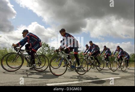 (Dpa) - i ciclisti del team US Postal pratica nel traffico normale durante una esecuzione pratica nei pressi di Limoges, Francia, 12 luglio 2004. Il team di produzione hanno utilizzato il primo giorno fuori del Tour de France corsa di ciclismo per rilassato le sessioni di formazione. Foto Stock