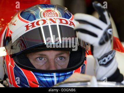 (Dpa) - British pilota di Formula Uno Jenson Button della Bar Honda mette sulla sua guanti prima che il corso di formazione gratuito sulla pista di Indianapolis, Stati Uniti d'America, 19 giugno 2004. Foto Stock