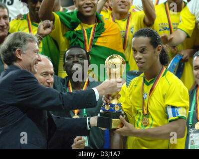 (Dpa) - Il presidente tedesco Horst Koehler (L) mani il trofeo al capitano brasiliano Ronaldinho dopo la squadra brasiliana aveva vinto la finale della Confederations Cup nel torneo di Francoforte, Germania, 29 giugno 2005. Il Brasile ha sconfitto Argentina 4-1. (Eds: l'uso di Internet e delle applicazioni mobili soggette alla FIFA di termini e condizioni) Foto Stock