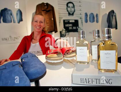 (Dpa) - un assistente vendite sorrisi come Ella presenta le pantofole e parfumes in occasione dell apertura di una moda e retail store che vende prodotti e articoli fabbricati da detenuti a Berlino, il 6 maggio 2004. Il penitenziario statale di Tegel vende sotto il marchio "Haeftling - Jailwear fin dal 1898 l' camicie, giacche, scarpe e borse via internet. che è il primo ogni ettaro Foto Stock