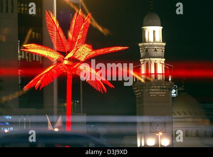 (Dpa) - Un'illuminata Palm tree sorge accanto al minareto della moschea di mercoledì sera a Manama, Bahrein, 31 marzo 2004. Formula 1 Gran Premio del Bahrain avrà luogo per la prima volta questa domenica, 4 aprile 2004. Foto Stock