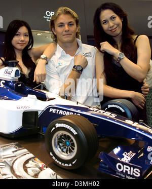 Tedesco di Formula One driver Nico Rosberg (C) della Williams F1 pone con due modelli asiatici in un negozio di orologi nel centro cittadino di Kuala Lumpur, Malesia, Mercoledì, 15 marzo 2006. Il Gran Premio di Malesia 2006 prende posto qui a Sepang 19 marzo 2006. Foto: Jens Buettner Foto Stock