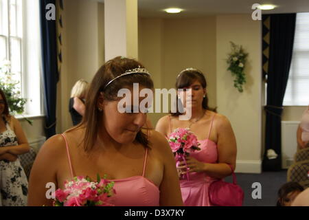 Due damigelle percorrendo a piedi l'isola in un ufficio del registro di sistema. Foto Stock