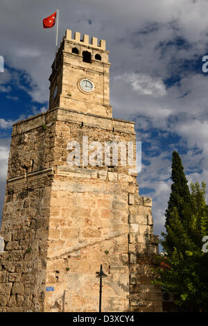 Saat Kulesi Clock Tower con bandiera turca sul muro romano in castello area di gate di Antalya, Turchia Foto Stock