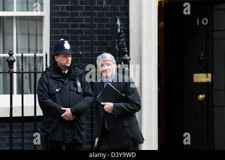 MP conservatore Andrew Mitchell passa da un funzionario di polizia come egli lascia il numero 10 di Downing Street a Londra il 23 marzo 2011. Foto Stock