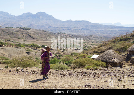 Ragazza locale con il bambino sul ciglio della strada in nord Africa Etiopia Foto Stock