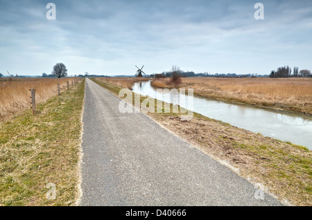 Percorso in bicicletta e mulino a vento nella campagna Olandese, Groningen Foto Stock