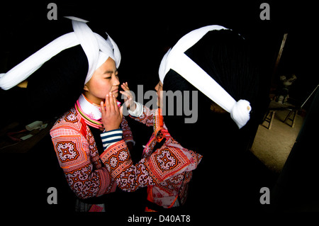 Long Horn Miao ragazze adolescenti ottenere pronto per l'Tiao Hua festival di Guizhou. Foto Stock