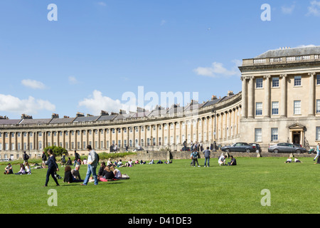 Ai visitatori di rilassarsi sul prato vicino al Royal Crescent, Bath, la terrazza curvo di case a schiera progettato da John Wood il vecchio. Foto Stock