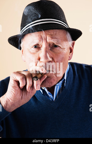 Ritratto di uomo Senior di fumare il sigaro Foto Stock